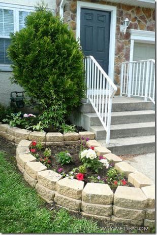picture of a small garden next to a concrete staircase with beautifully installed flowers and pavers in a seattle washington home